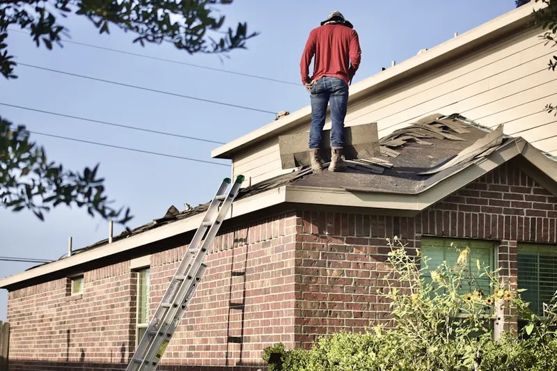 Professional roofer working on a residential roof in Rocklane Estates